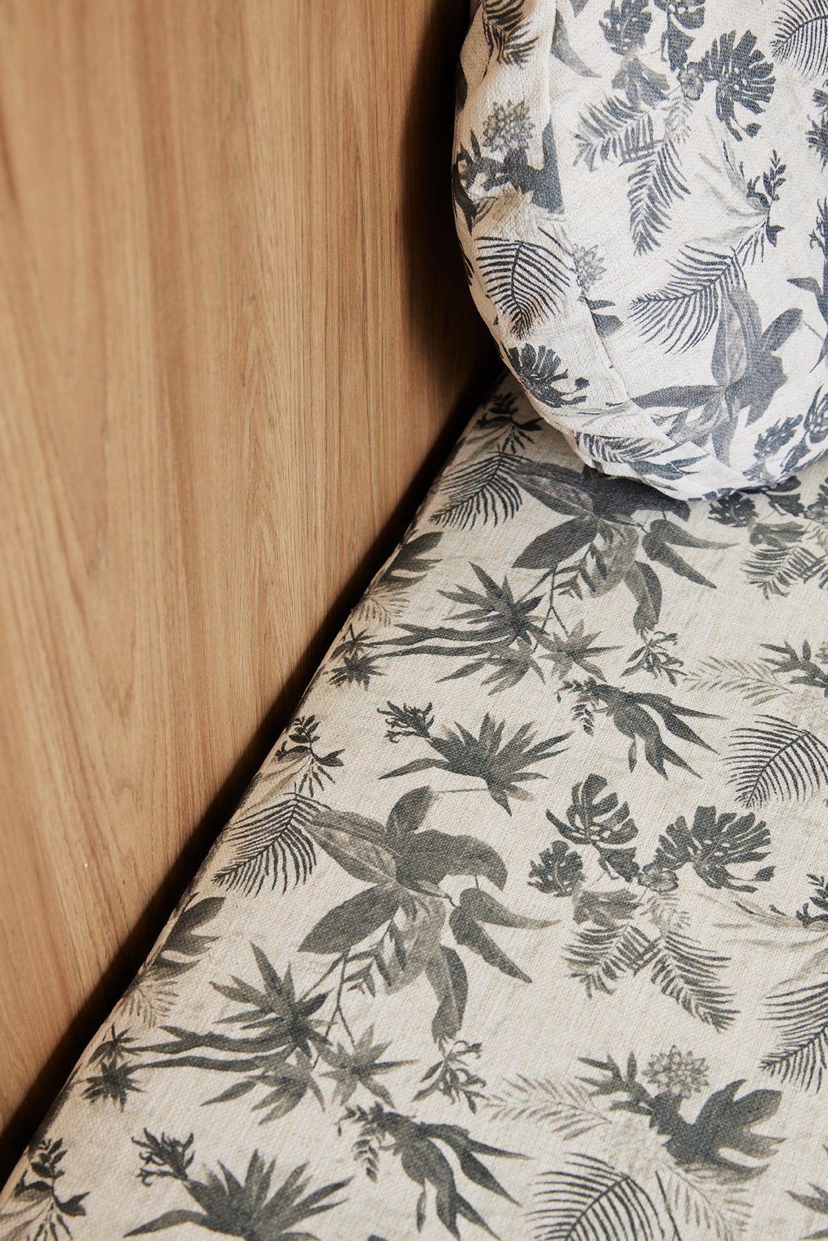 Close-up of Boheme Paradise linen fabric on a banquette seat and round cushion