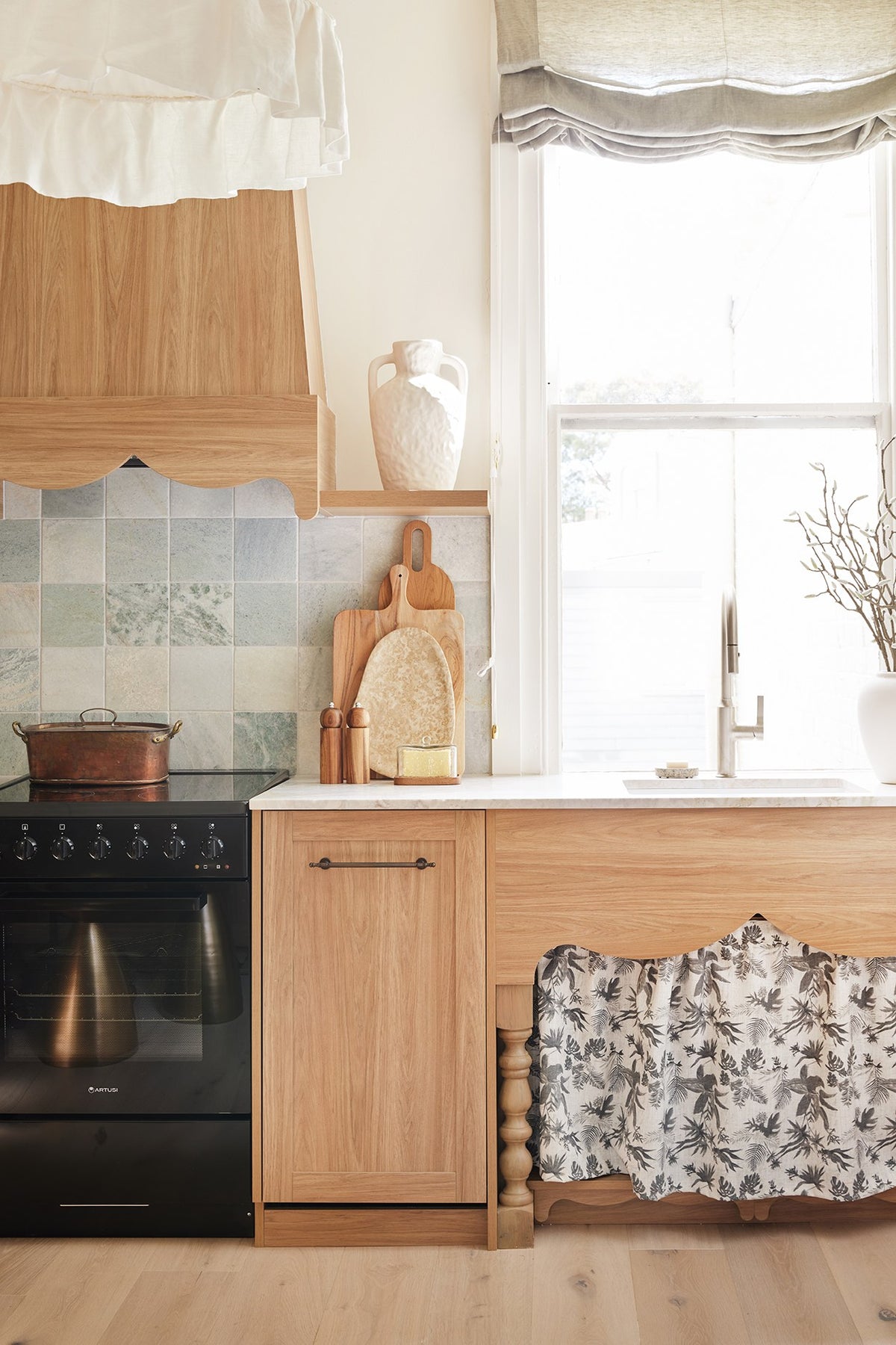 Gathered Boheme Paradise fabric sink skirt under a timber kitchen bench